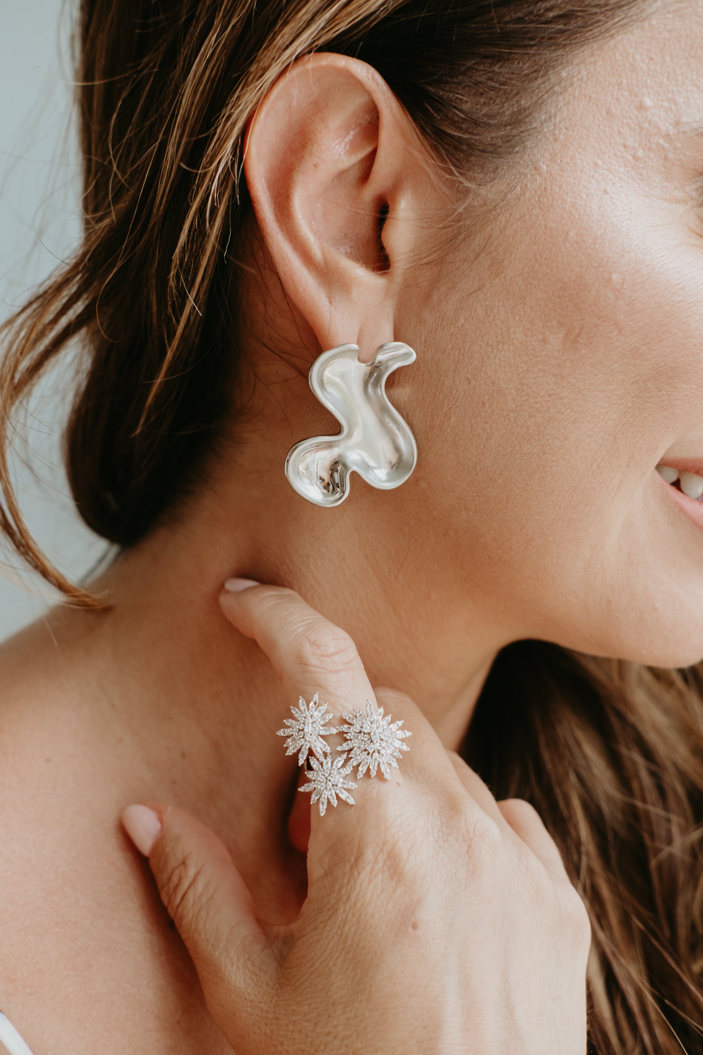 rhodium sculptural earrings styled for professional women modern elegant statement jewelry look