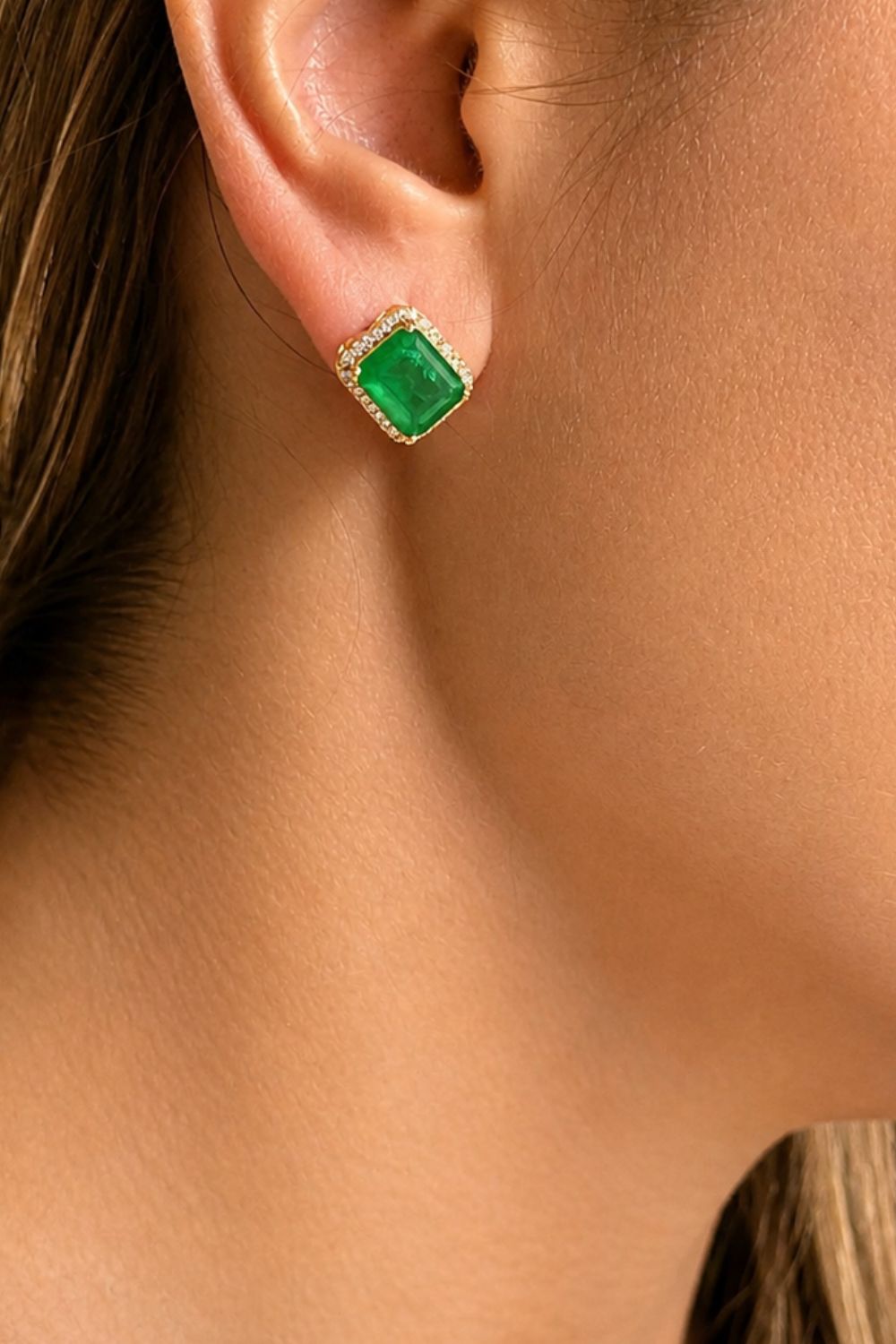 emerald stone gold earrings styled for professional women elegant statement jewelry look