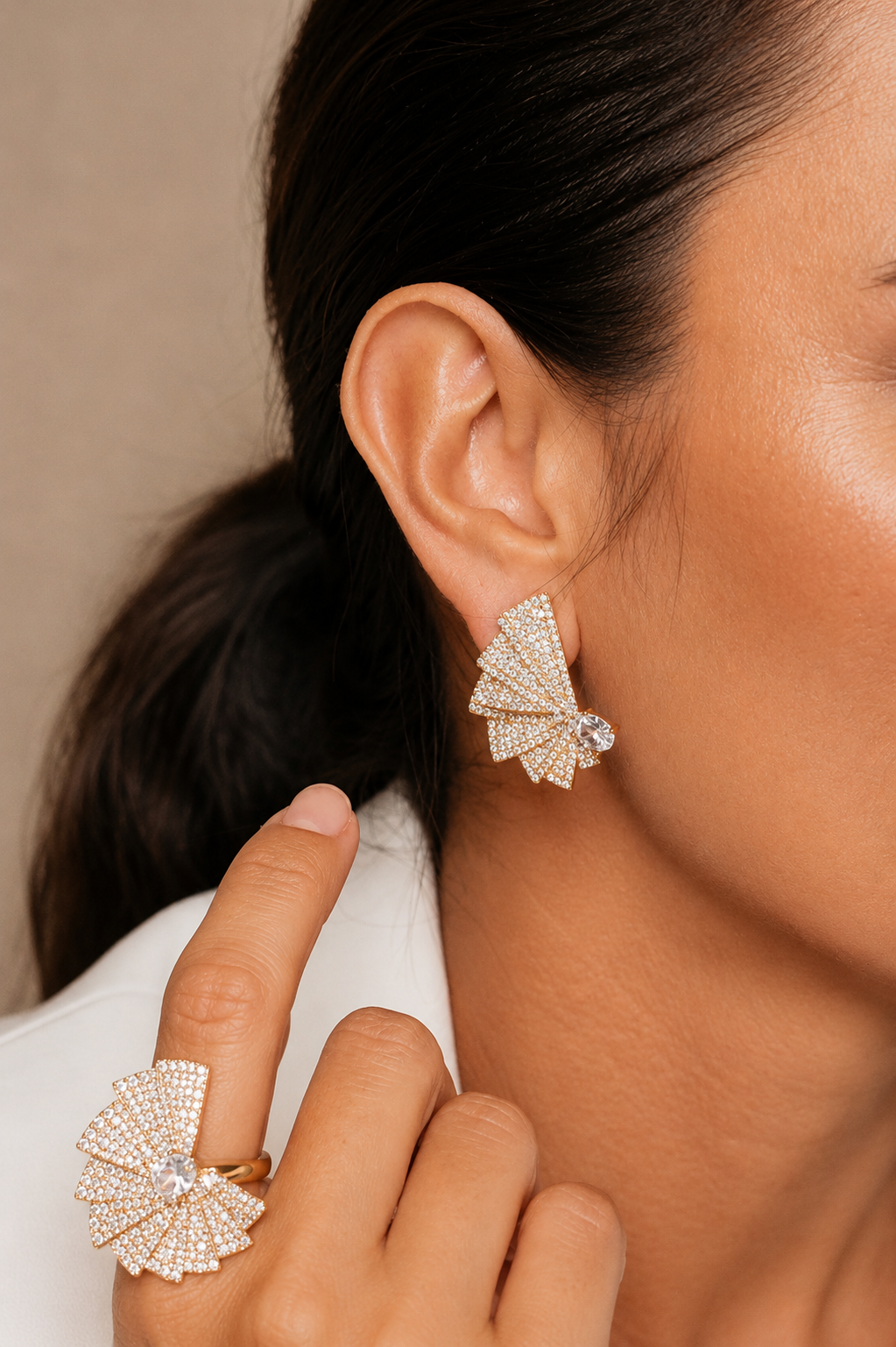 fan shaped zirconia statement earrings worn on model gold sculptural stud earrings luxury styling