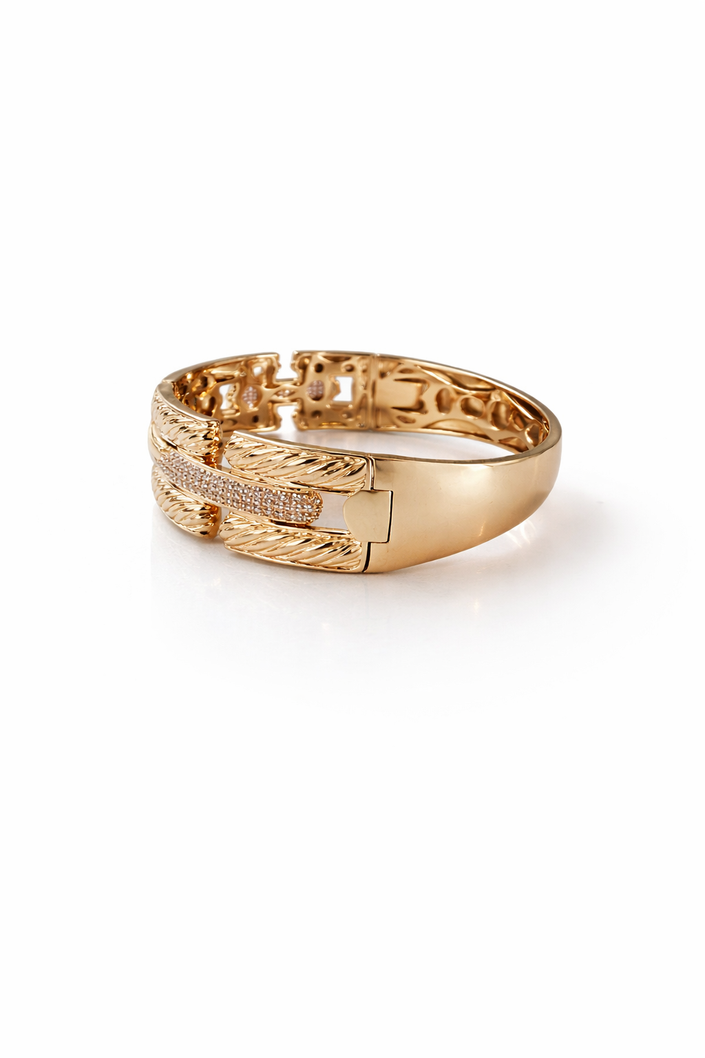 gold cuff bracelet with intricate groove texture and zirconia stones luxury jewelry detail design
