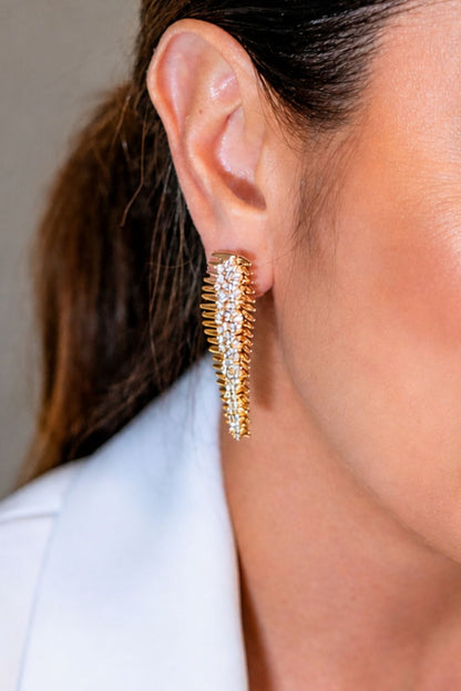 gold vertical zirconia earrings worn on ear modern elongated statement jewelry look