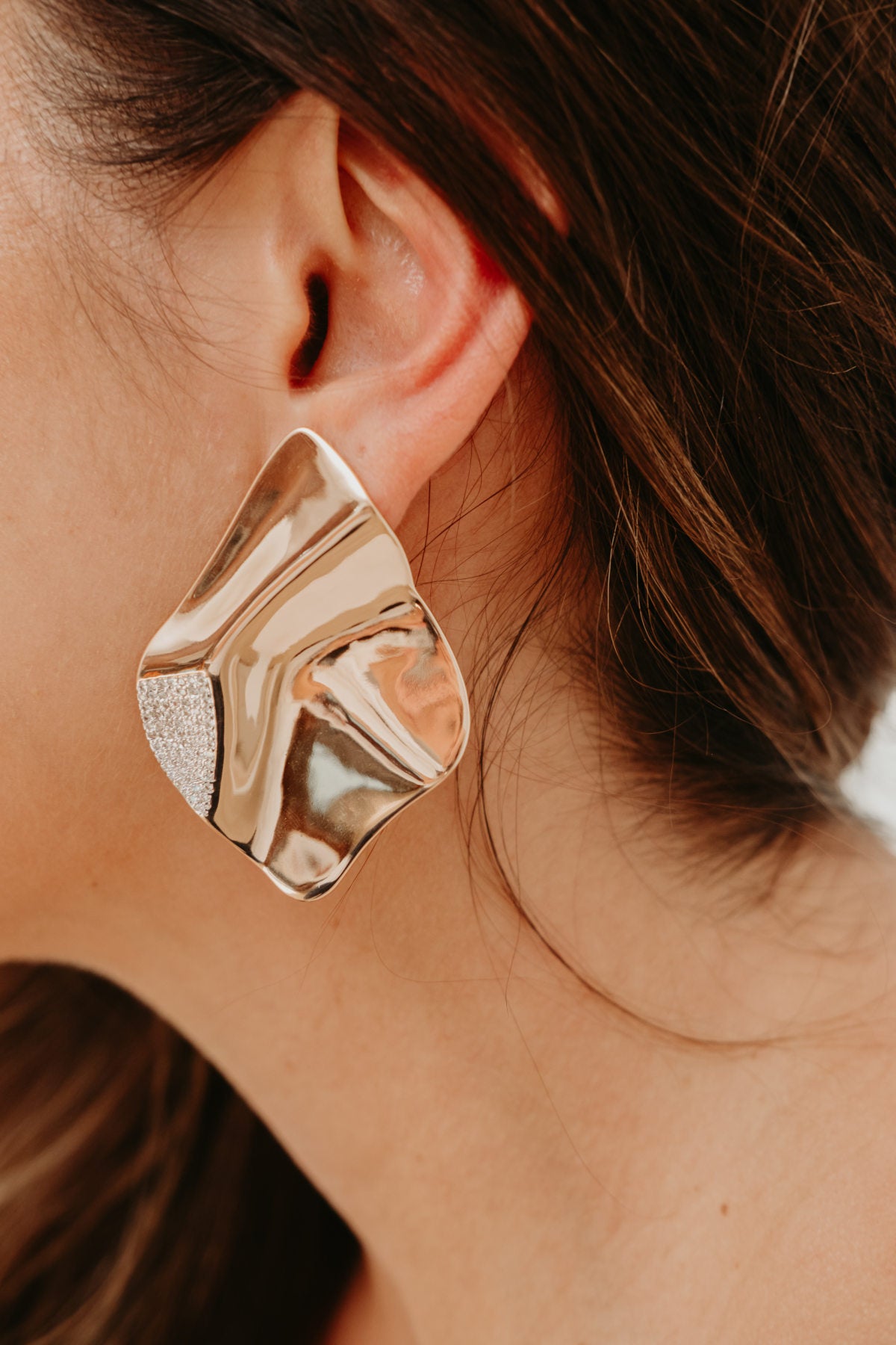 Oversized gold statement earrings for women featuring a modern sculptural silhouette