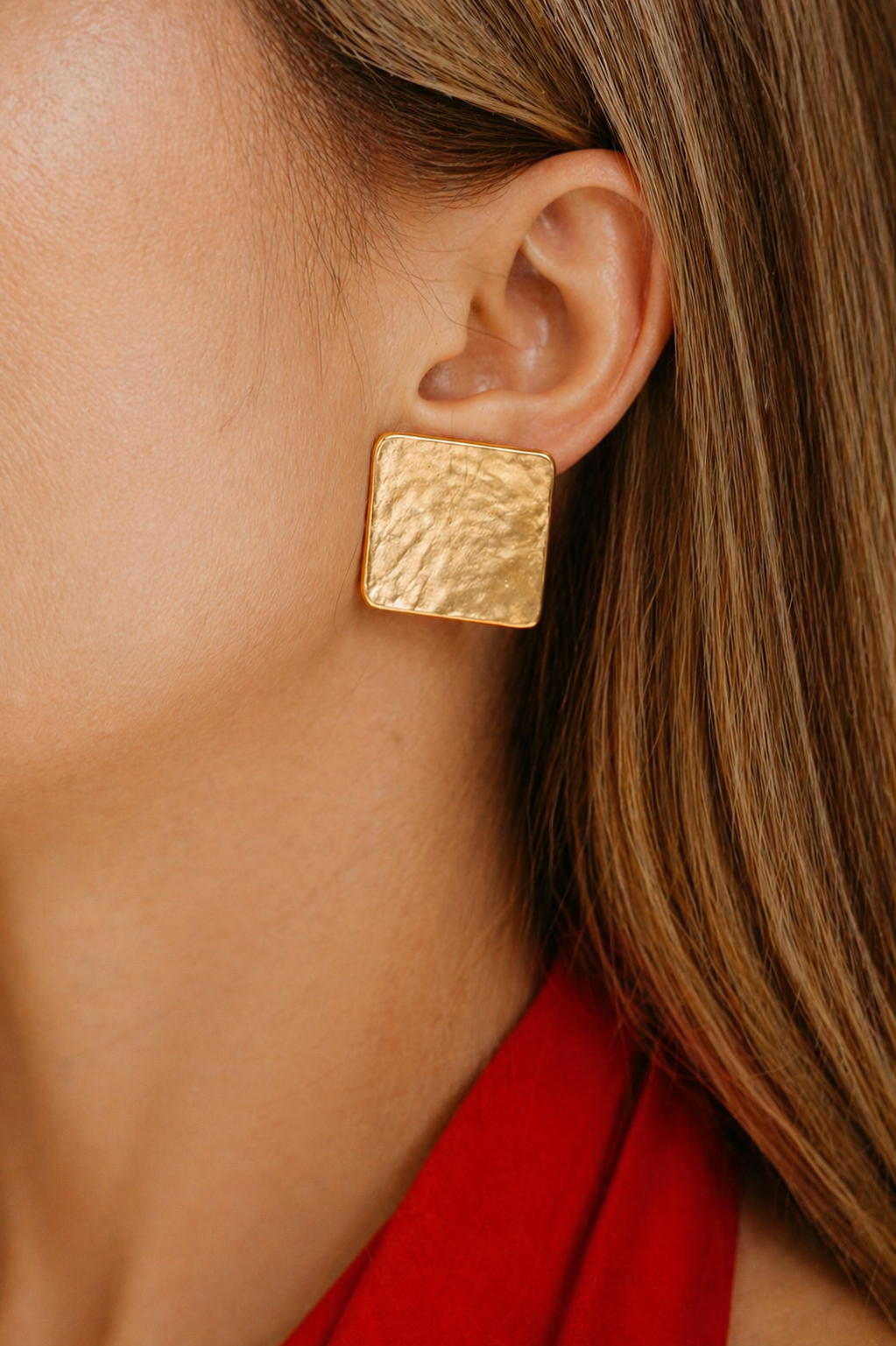 gold textured stud earrings styled for women elegant modern statement jewelry minimal luxury look
