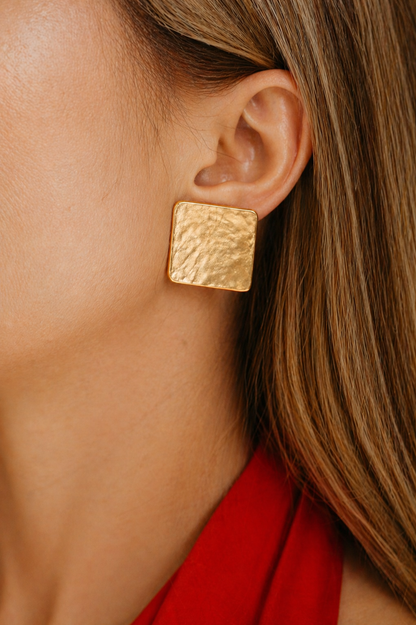 gold textured stud earrings styled for women elegant modern statement jewelry minimal luxury look