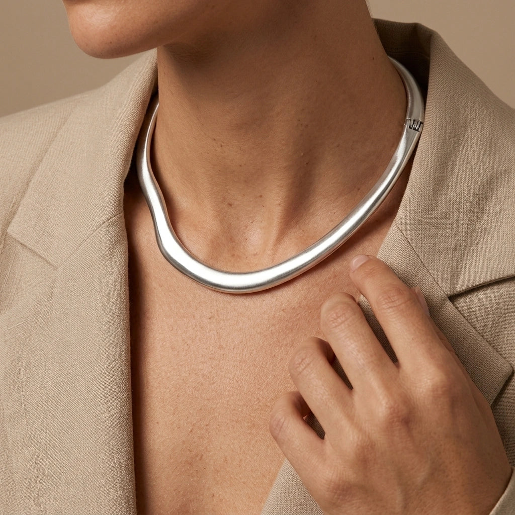 silver tone collar choker necklace with curved asymmetrical design polished modern luxury statement jewelry