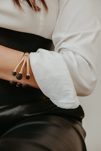 18K gold plated statement bracelet featuring handset black zirconia pavé on rounded sculptural ends