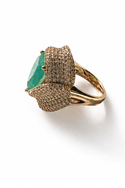 sculptural gold statement ring with tourmaline center and layered zirconia wrap design