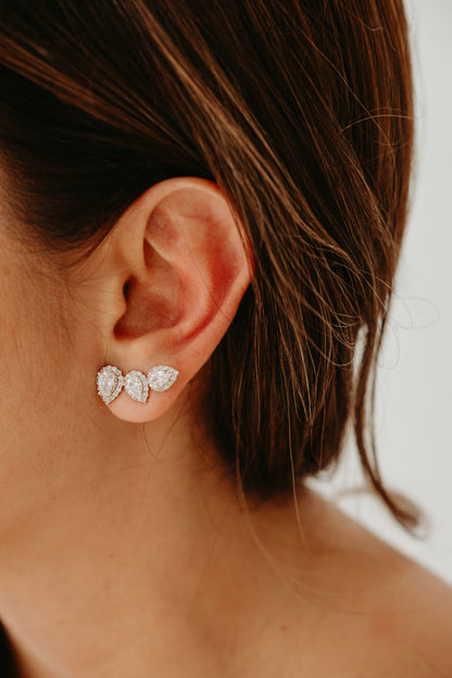 Rhodium plated ear climber earrings with three pear shaped zirconia stones and sparkling halo detailing