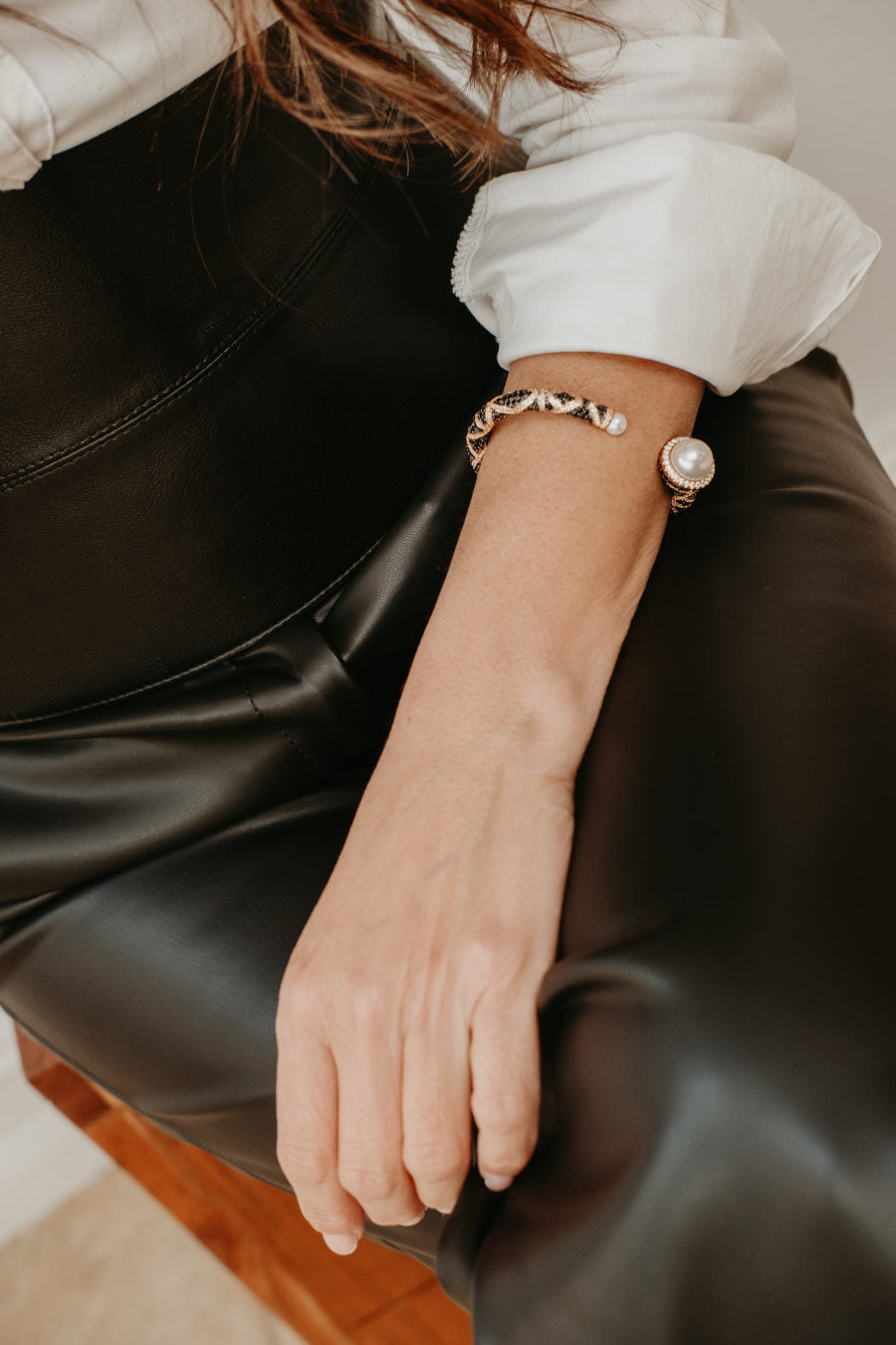 Sculptural 18K gold plated open cuff bracelet featuring rounded faux pearls and zirconia accents