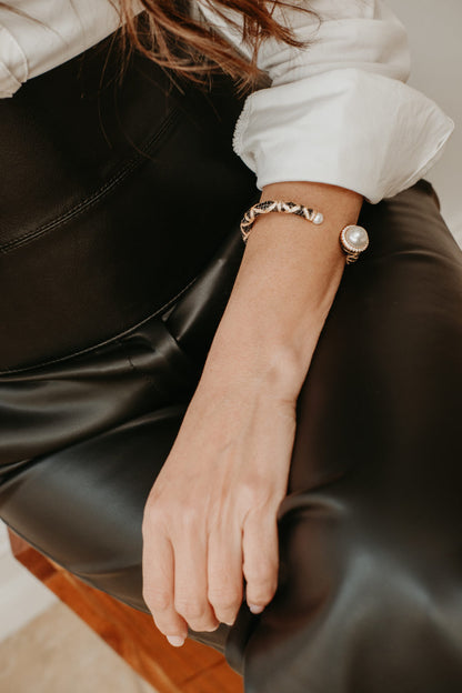 Sculptural 18K gold plated open cuff bracelet featuring rounded faux pearls and zirconia accents