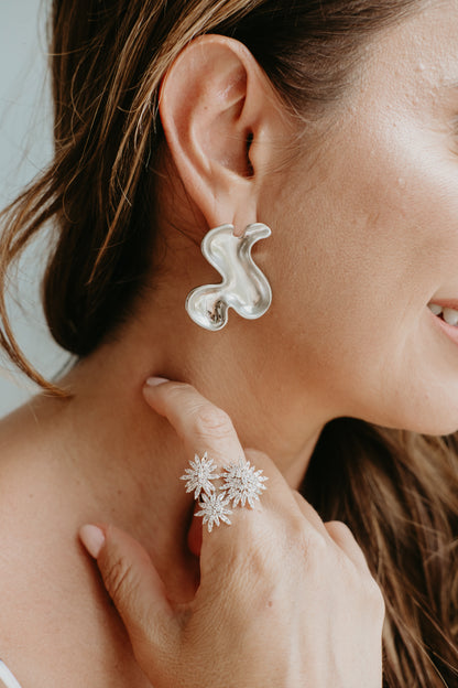 rhodium sculptural earrings styled for professional women modern elegant statement jewelry look