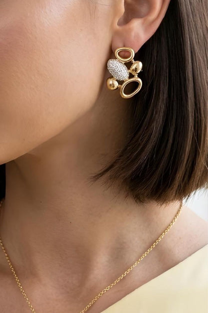 Gold statement earrings featuring abstract rounded shapes, open hoops and brilliant zirconia detailing