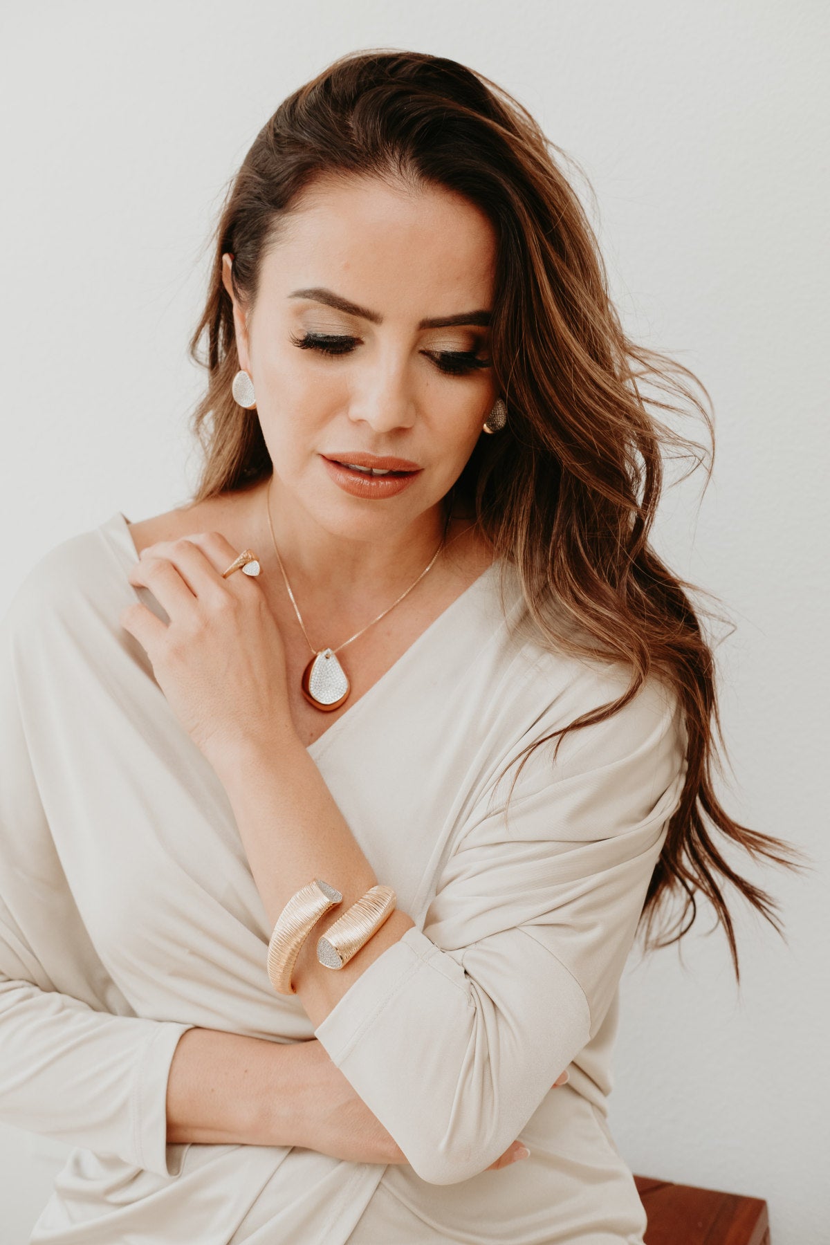 Luxury gold cuff bracelet for women featuring fine linear texture and sparkling handset zirconia tapered ends