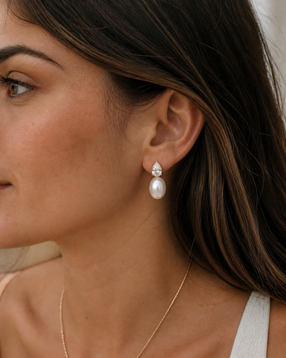 gold drop earrings with pear cut zirconia and faux pearl elegant statement jewelry with fluid movement