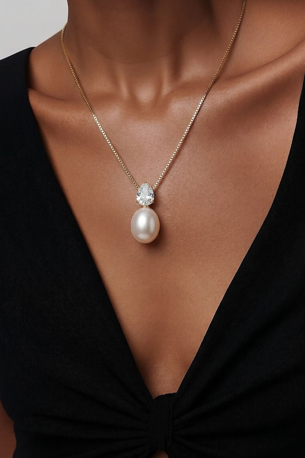 gold necklace with pear cut zirconia and faux pearl pendant luxury jewelry detail design