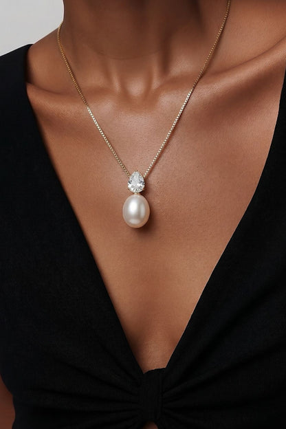 gold necklace with pear cut zirconia and faux pearl pendant luxury jewelry detail design