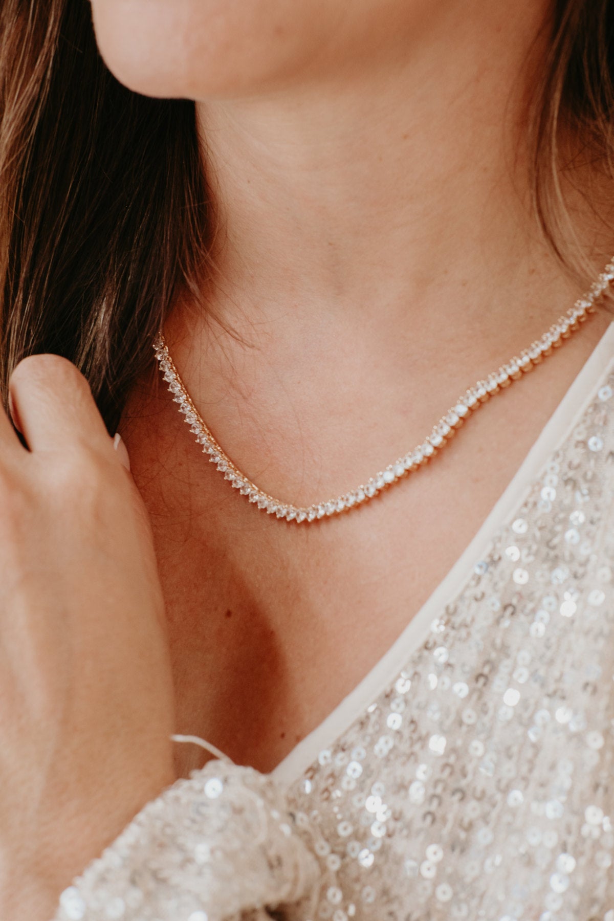 gold Riviera necklace worn on neck zirconia stones close up luxury jewelry detail look