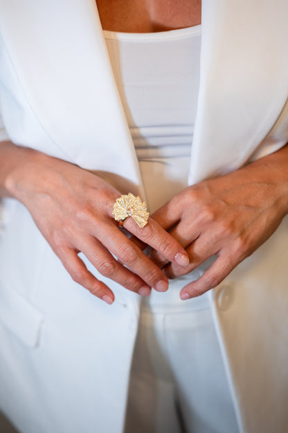 gold fan statement ring with central zirconia and radiating pavé design luxury jewelry