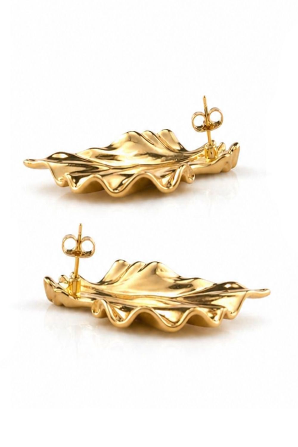 gold sculpted earrings with flowing grooves polished architectural design luxury jewelry detail