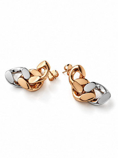 A pair of chunky interlocking chain link earrings in a two tone finish, combining polished 18 k gold plated and rhodium plated metal 